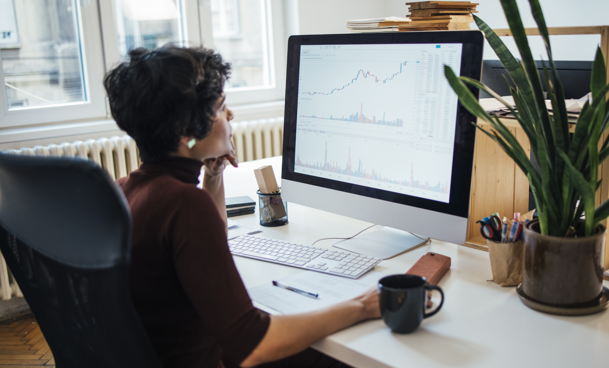 Businesswoman viewing graphs on a computer